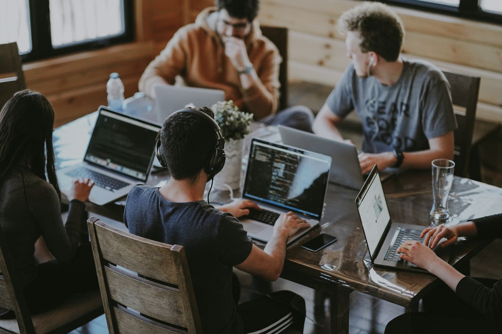 A team collaborating around a laptop